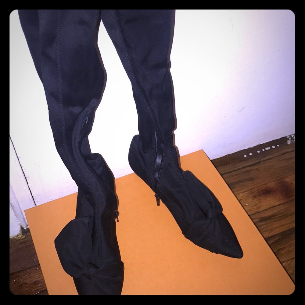 Over the knee black satin boots.